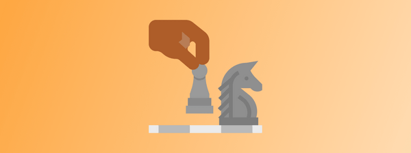 strategy: a person's hand moving a chess piece